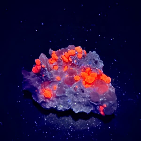 Quartz and calcite with mica under UV light, from Hunan, China