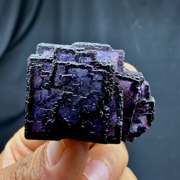 QR-code purple-framed fluorite cube glowing when, from Inner Mongolia, China, close-up of the crystal faces