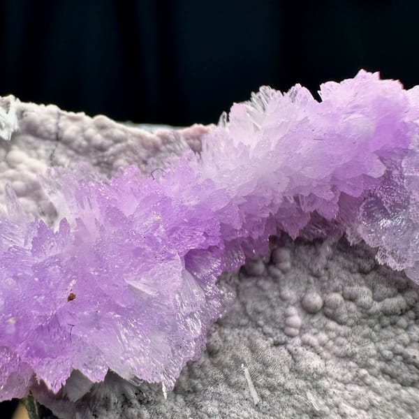 Pink aragonite band across pale grey matrix from Yunnan, China, second angle