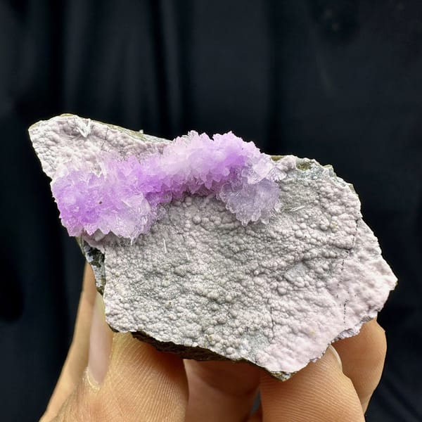 Pink aragonite band across pale grey matrix from Yunnan, China, detail of the matrix contact