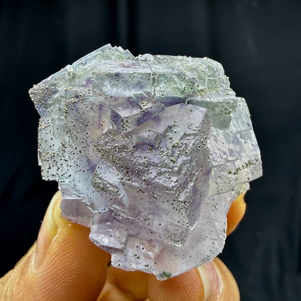 Purple-cored fluorite cubes dusted with pyrite from Yaogangxian Mine, Hunan, China, close-up of the crystal faces