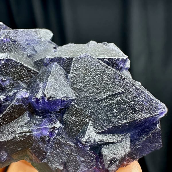 Purple and green octahedral fluorite glowing when, from Zhejiang, China, close-up of the crystal faces