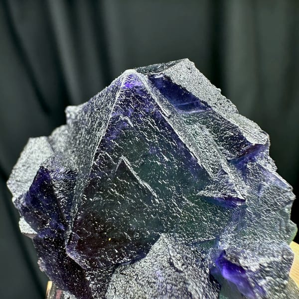Purple and green octahedral fluorite glowing when, from Zhejiang, China, reverse side