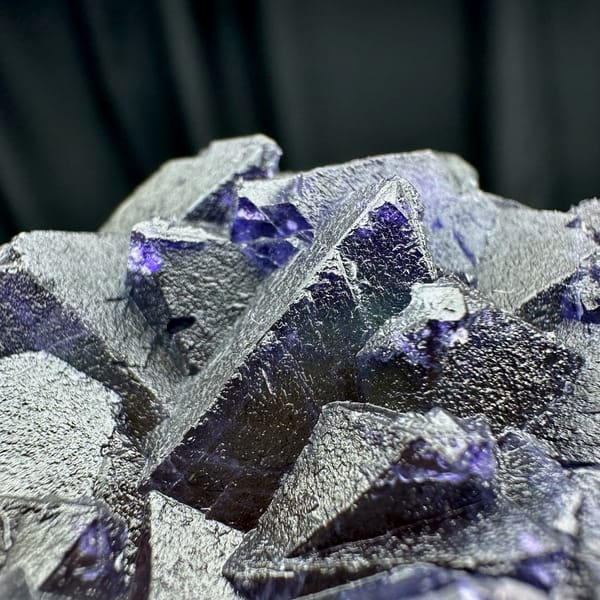 Purple and green octahedral fluorite glowing when, from Zhejiang, China, top view