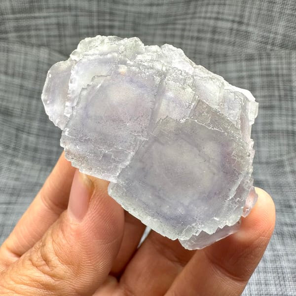 Large purple-framed fluorite crystal with frosted skin from Guangxi, China, side view