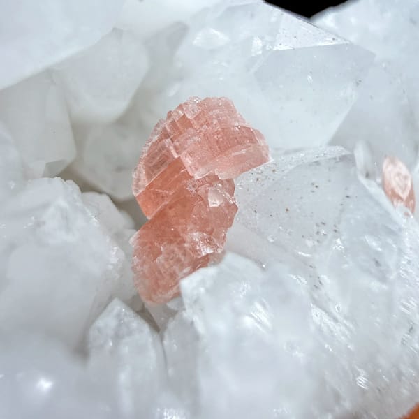 Pink rhodochrosite patch inside white quartz cluster from Guangxi, China, close-up of the crystal faces
