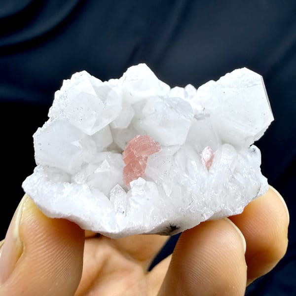 Pink rhodochrosite patch inside white quartz cluster from Guangxi, China, detail of the matrix contact