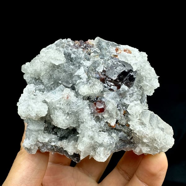 Sphalerite with quartz and calcite, from Hunan, China, front view in daylight, held in hand