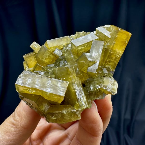 Glassy golden baryte blades with pale fluorite from Jiangxi, China, close-up of the crystal faces