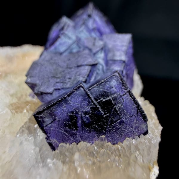 Two deep purple fluorite cubes on white quartz plate from Inner Mongolia, China, reverse side