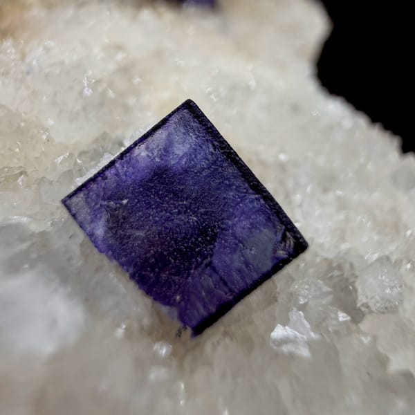 Two deep purple fluorite cubes on white quartz plate from Inner Mongolia, China, top view