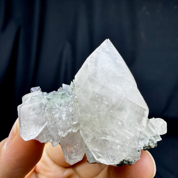 Large double-terminated calcite with green fluorite octahedra from Fujian, China, detail of the matrix contact