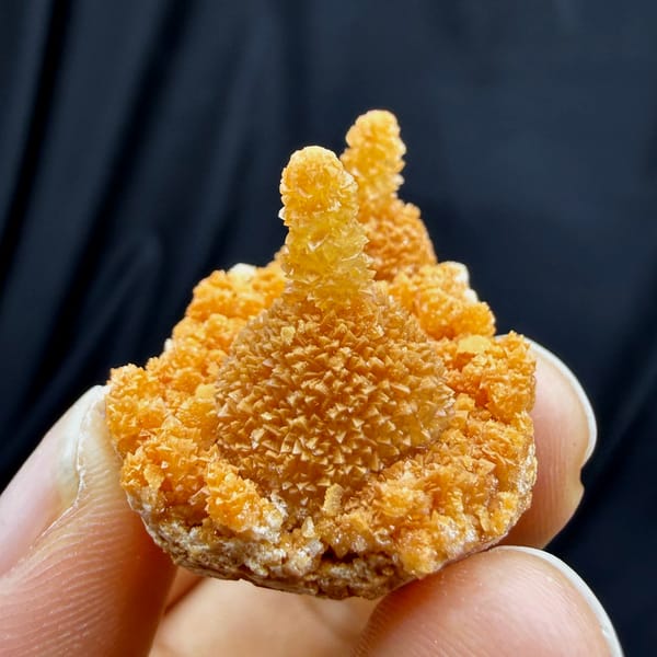 Orange stalactitic calcite crown with sugary skin from Yunnan, China, close-up of the crystal faces