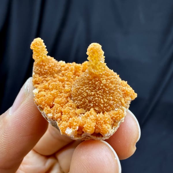 Orange stalactitic calcite crown with sugary skin from Yunnan, China, reverse side