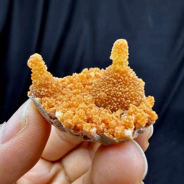 Orange stalactitic calcite crown with sugary skin from Yunnan, China, top view