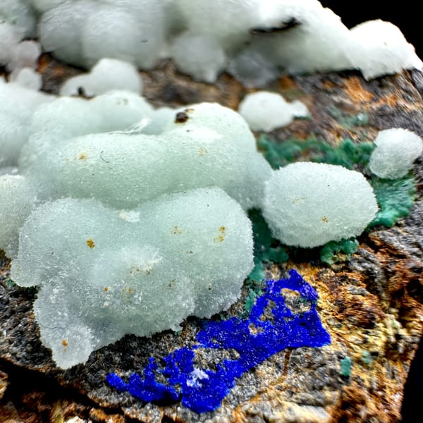 Pastel blue aragonite balls with malachite and azurite from Yunnan, China, close-up of the crystal faces