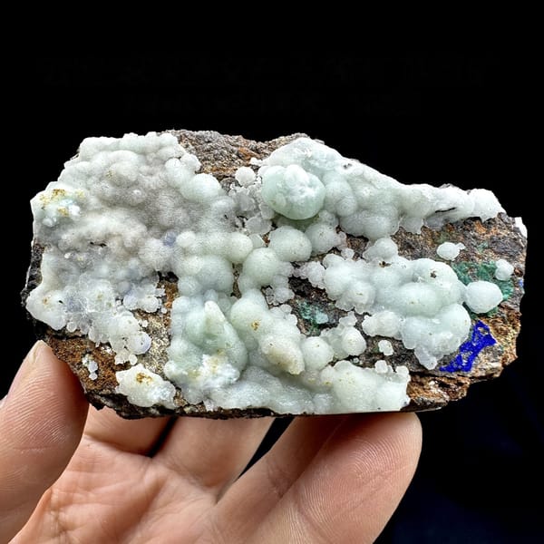Pastel blue aragonite balls with malachite and azurite from Yunnan, China, detail of the matrix contact