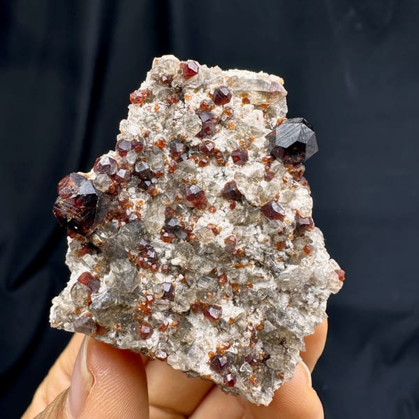 Wine-red garnets crowding cream feldspar with smoky quartz from Yunxiao, Fujian, China, second angle