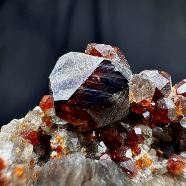 Wine-red garnets crowding cream feldspar with smoky quartz from Yunxiao, Fujian, China, reverse side