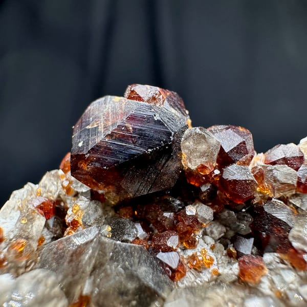 Wine-red garnets crowding cream feldspar with smoky quartz from Yunxiao, Fujian, China, top view