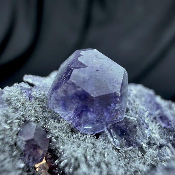 Violet-blue fluorite cubes on grey quartz druse from Fujian, China, reverse side