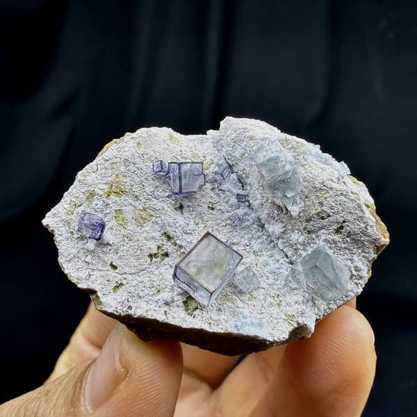 Purple-framed clear fluorite cubes on grey quartz from Inner Mongolia, China, detail of the matrix contact