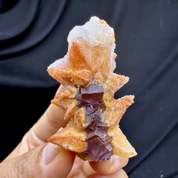 Purple-red fluorite cubes between tan calcite blades from Yunnan, China, second angle