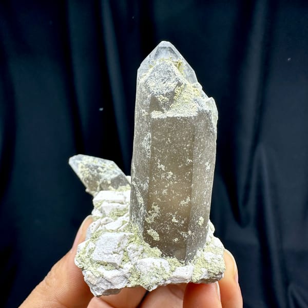 Smoky quartz prism piercing cream feldspar block from Fujian, China, close-up of the crystal faces