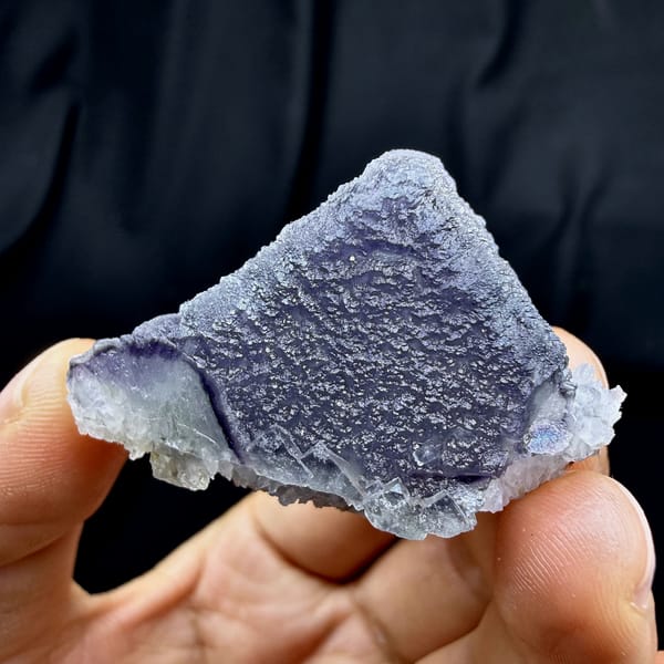 Frosted purple fluorite cube on sparkling white quartz from Fujian, China, close-up of the crystal faces