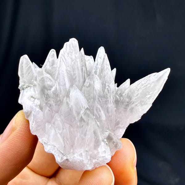 Pale pink feather-calcite crown of pointed blades from Hunan, China, close-up of the crystal faces