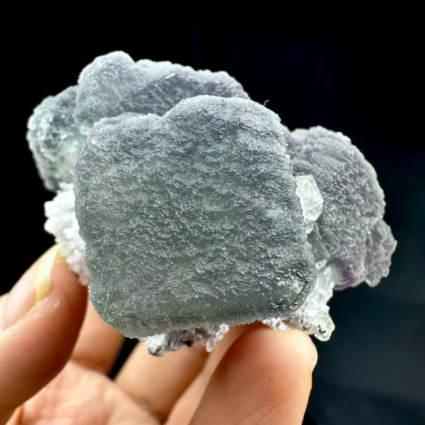Frosted purple and green fluorite mass with matte skin from Fujian, China, close-up of the crystal faces