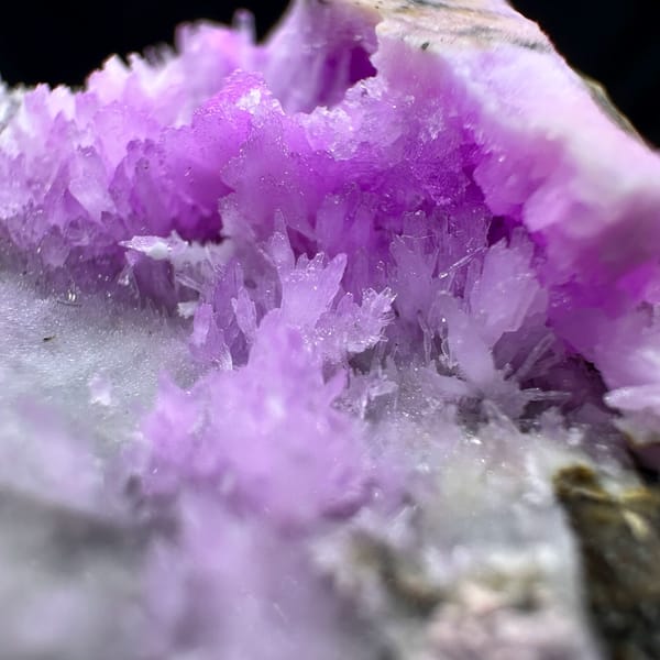Magenta aragonite patch on pale grey matrix from Yunnan, China, close-up of the crystal faces