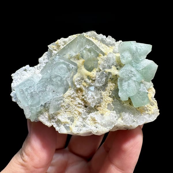 Pale green fluorite octahedra on yellow-crusted matrix from Xianghualing, Hunan, China
