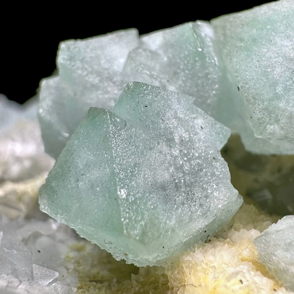Pale green fluorite octahedra on yellow-crusted matrix from Xianghualing, Hunan, China, second angle