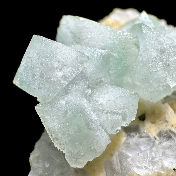 Pale green fluorite octahedra on yellow-crusted matrix from Xianghualing, Hunan, China, reverse side