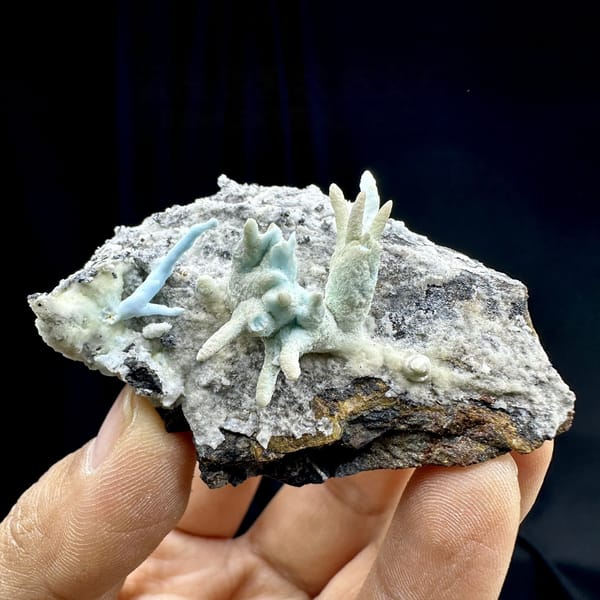 Blue-green stalactitic aragonite fingers on grey rock from Yunnan, China, top view