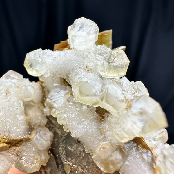 White calcite prisms on golden-brown siderite from Guizhou, China, top view