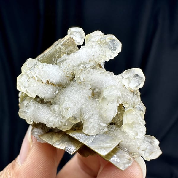 White calcite prisms on golden-brown siderite from Guizhou, China, detail of the matrix contact