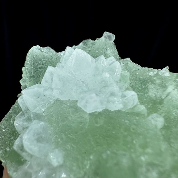 Mint-green fluorite mass with white quartz patch from Guangdong, China, close-up of the crystal faces