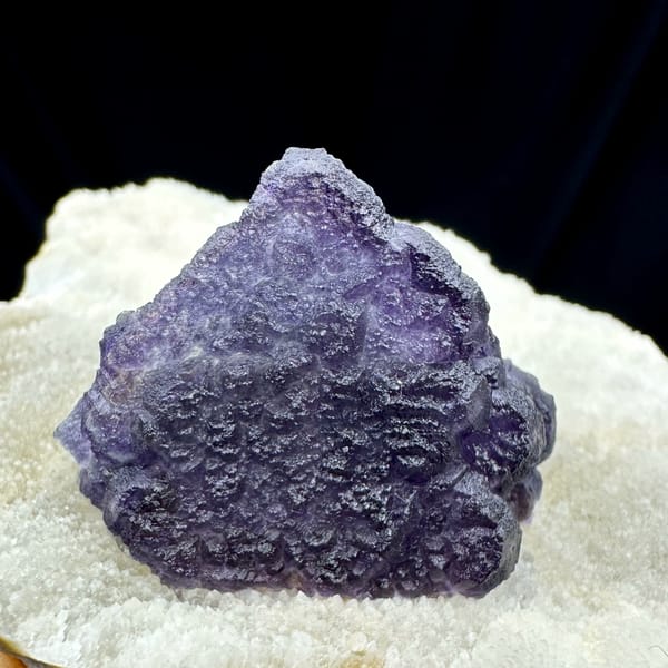 Purple fluorite half-wrapped in white quartz from Inner Mongolia, China, close-up of the crystal faces