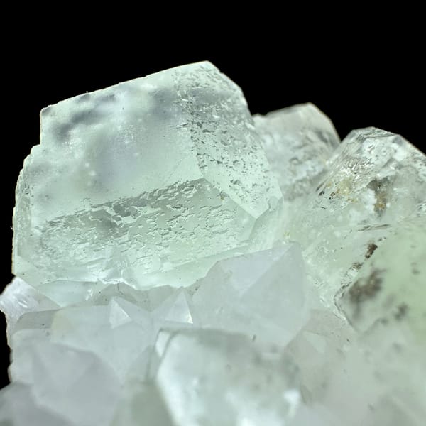 Pale green fluorite cubes with inclusions on white quartz from Guangdong, China, top view