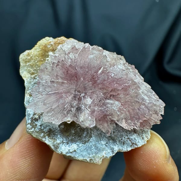 Pink radiating creedite flowers on tan matrix from Guizhou, China, second angle