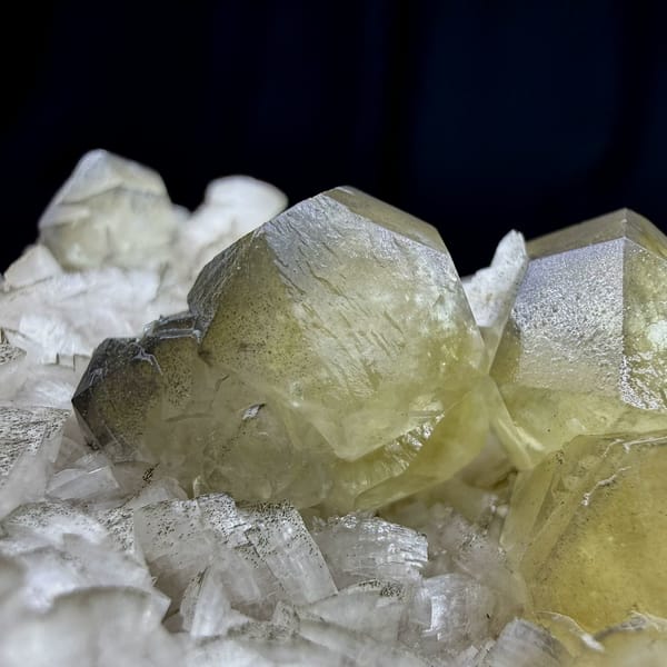 Pale yellow calcite crystal on cream dolomite rhombs from Guizhou, China, top view