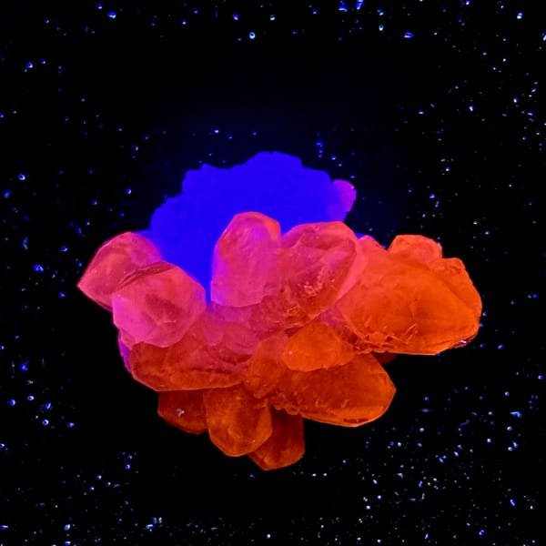 Stepped green fluorite with calcite under UV light, from Fujian, China