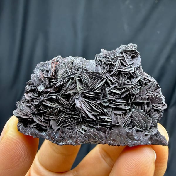 Black-rose specular hematite plate of overlapping petals from Guangdong, China, detail of the matrix contact