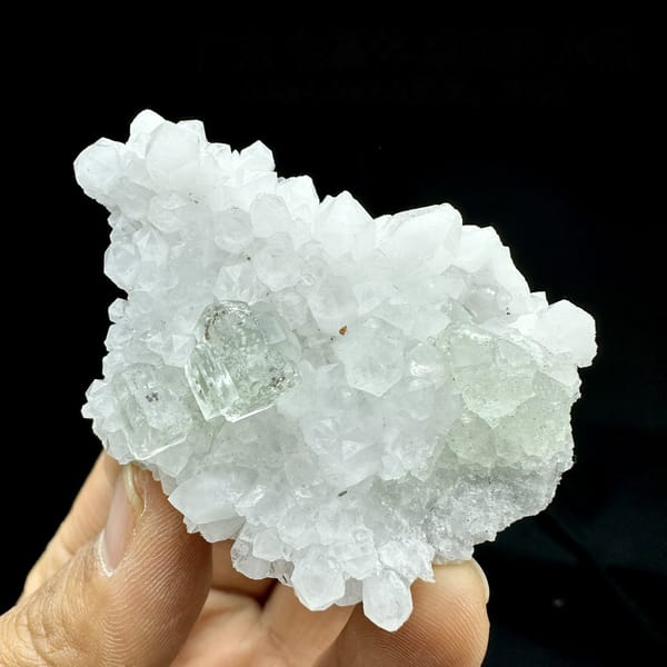 Pale green fluorite cube nested in white quartz points from Guangdong, China, detail of the matrix contact