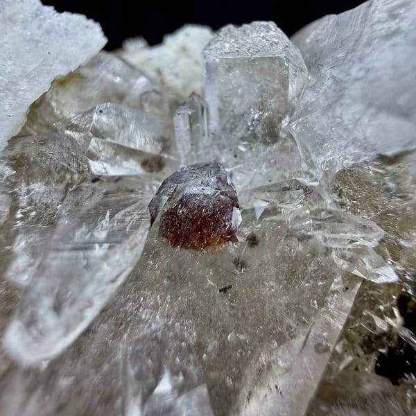 Pale quartz floater with garnet, apophyllite and chabazite from Yunxiao, Fujian, China, close-up of the crystal faces