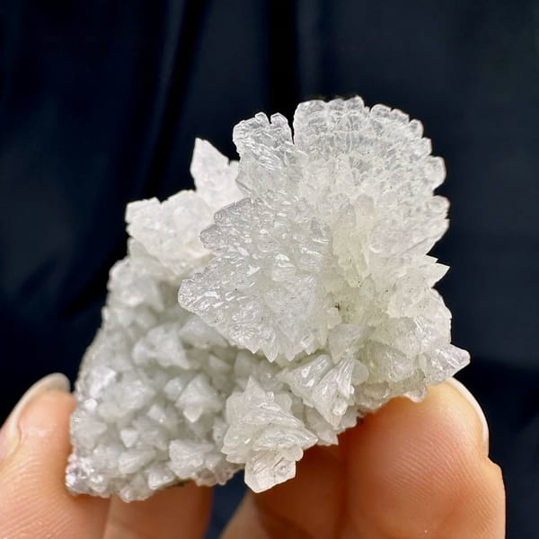 White calcite cluster from Guizhou, China, held in hand