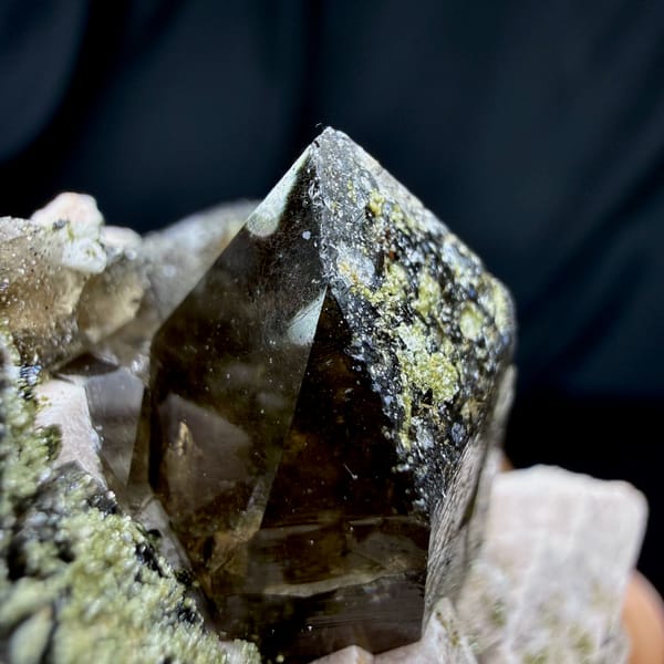 Dark smoky quartz crystals with cream feldspar and mica from Yunxiao, Fujian, China, close-up of the crystal faces
