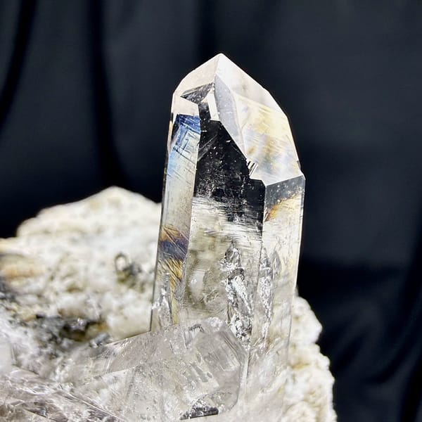 Tall clear quartz prism rising from cream feldspar from Yunxiao, Fujian, China, top view